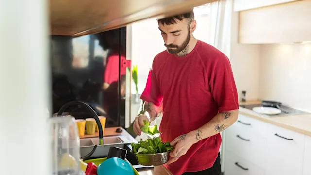 hematology: man rinsing leafy vegetables 1284024912