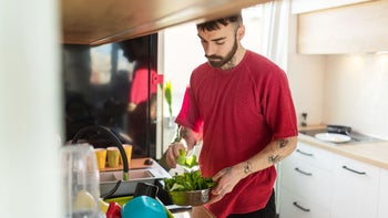hematology: man rinsing leafy vegetables 1284024912