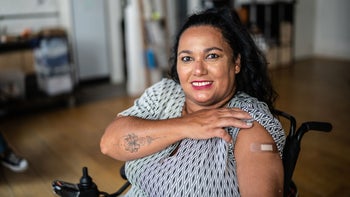 Vaccines: woman smiling bandaid vaccine 1372608264