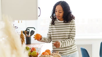 Diet Nutrition: woman holding an orange 1396814181