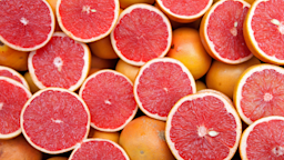 A close-up of a sliced grapefruit. Grapefruit is one of the foods you should avoid if you’re taking beta blockers like carvedilol.
huseyintuncer/iStock via Getty Images Plus
