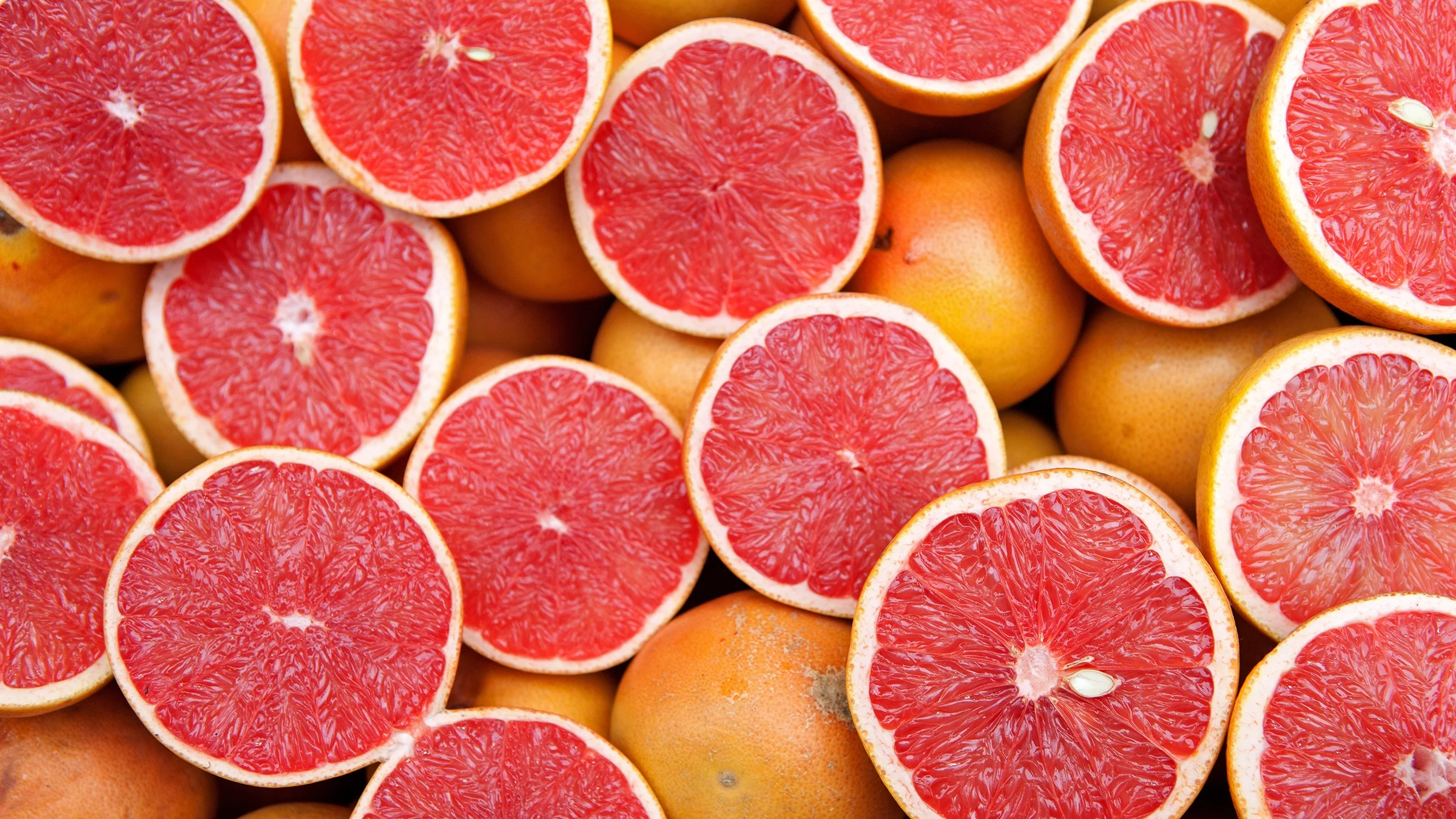 A close-up of a sliced grapefruit. Grapefruit is one of the foods you should avoid if you’re taking beta blockers like carvedilol.