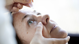 Close-up of a woman getting eye drops.
Xesai/E+ via Getty Images 
