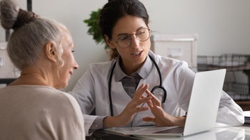 Health: Colon cancer: doctor reviewing with patient something on laptop-1305317737