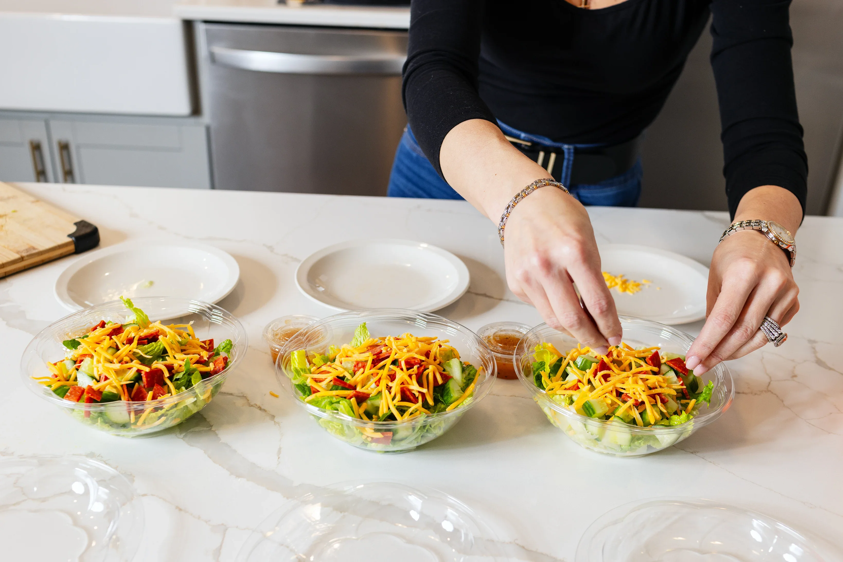 Close-up Kat Carollo meal preps in her kitchen at home in Wenonah, New Jersey.