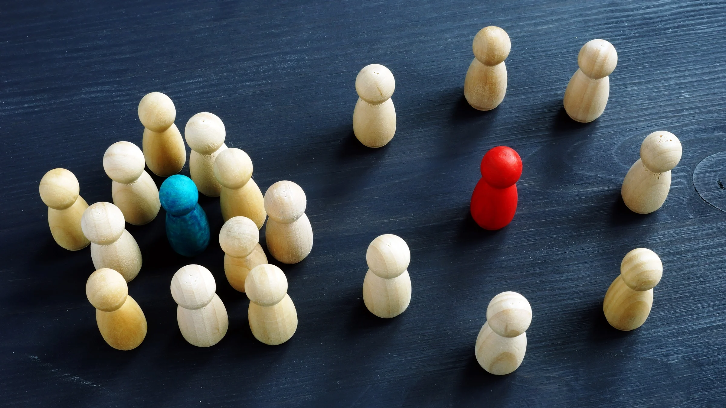 Introvert and extrovert concept with wooden figurines on a desk