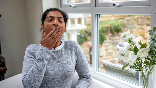Xywav: woman yawning from daytime sleepiness 1356375917