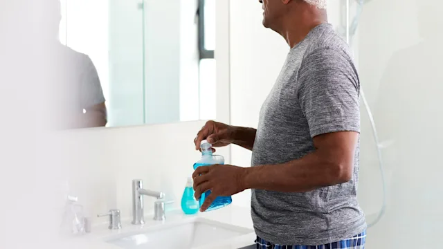 Dental Care: man using mouthwash 1132797553