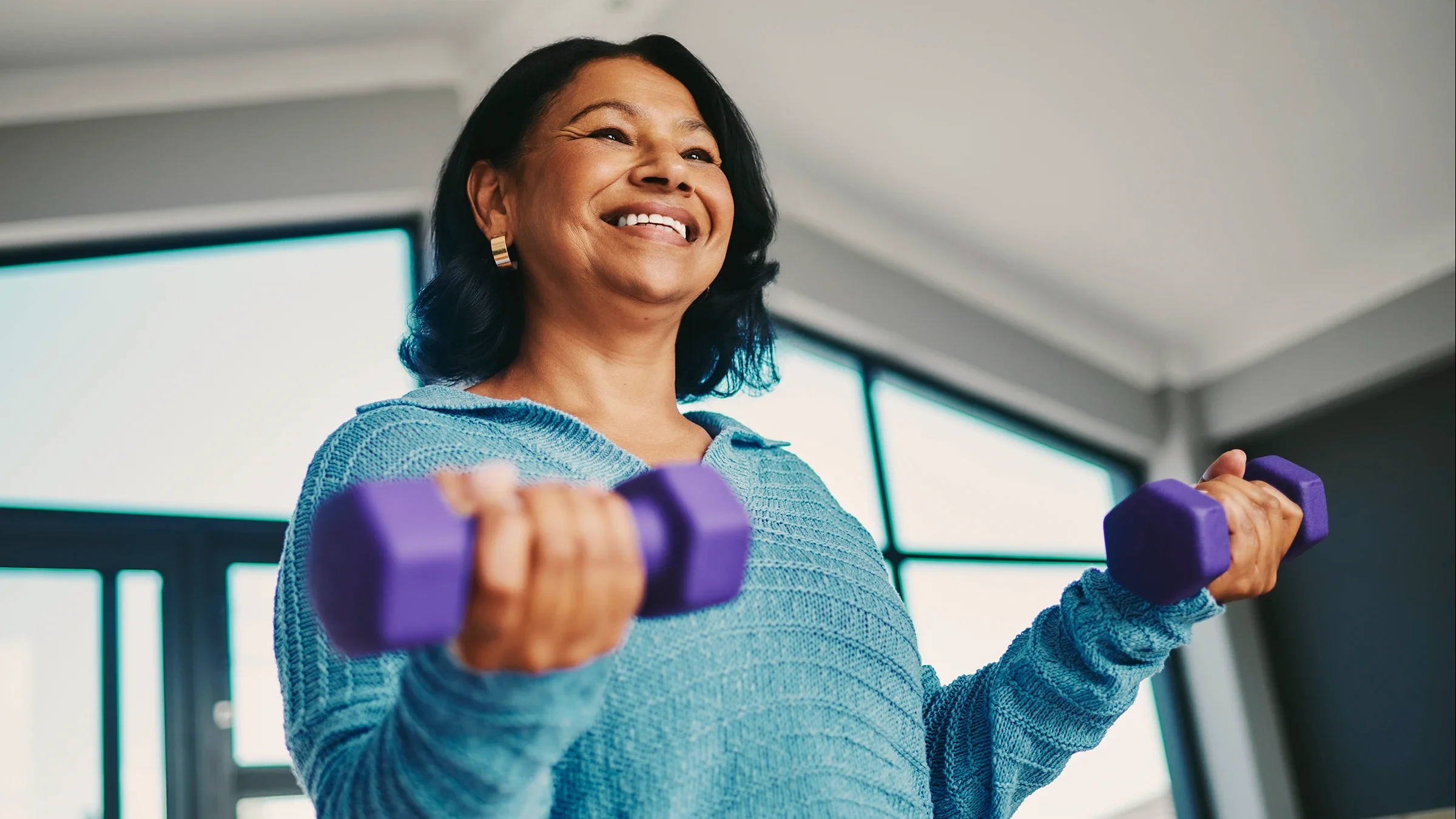A woman does bicep curls.
