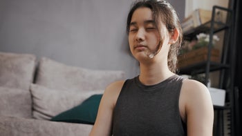 Childrens health: teenager doing breathing exercise at home 1400658908