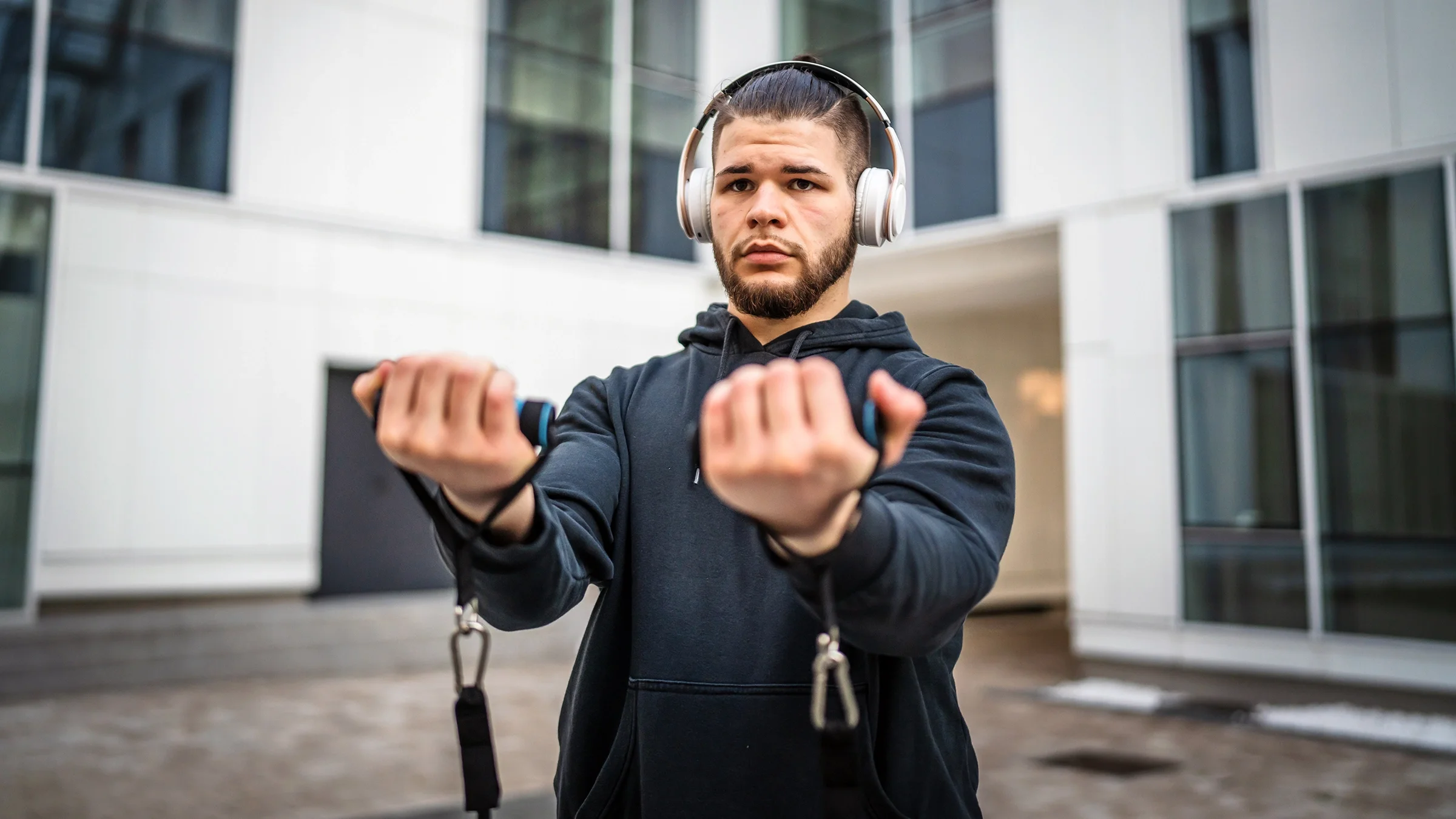 Man training outdoors with resistance bands.