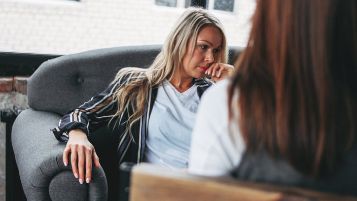 A therapy client thinking and looking frustrated.