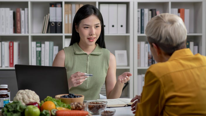 A nutritionist in a consultation with a client.