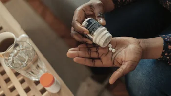 Health: Fertility: overhead woman taking pills-1309889567