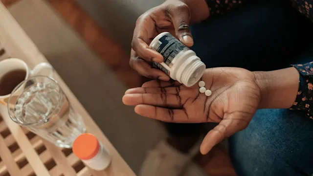 Health: Fertility: overhead woman taking pills-1309889567