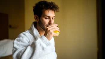 erectile dysfunction: drinking orange juice wearing robe 2182306653