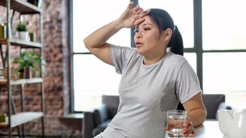 Menopause: woman with hot flash 973780504