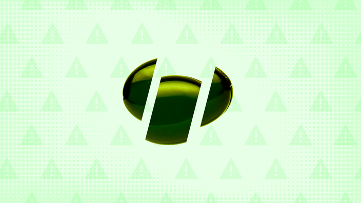 Light green background with texture and warning sign pattern. In the center is a dark green gel capsule cut into thirds. 