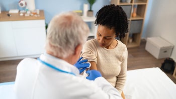 Vaccines: woman receiving vaccine shot 2135092419