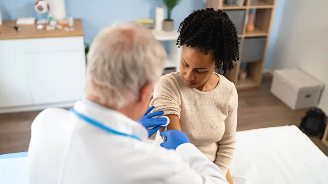 Vaccines: woman receiving vaccine shot 2135092419
