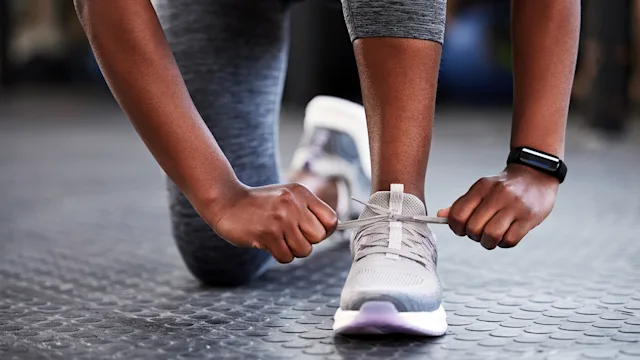 Movement exercise: closeup woman tying shoelace 1359197182