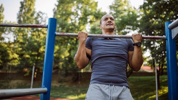 movement exercise: man doing pullup 1155865725