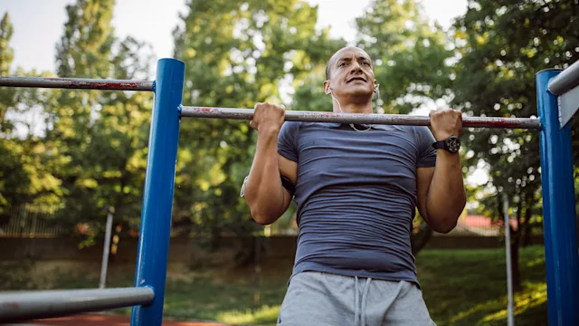 movement exercise: man doing pullup 1155865725