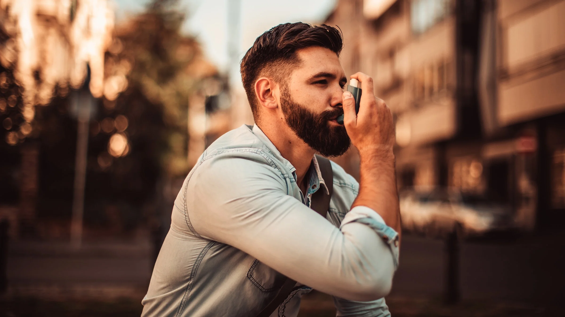 A hipster using an inhaler.