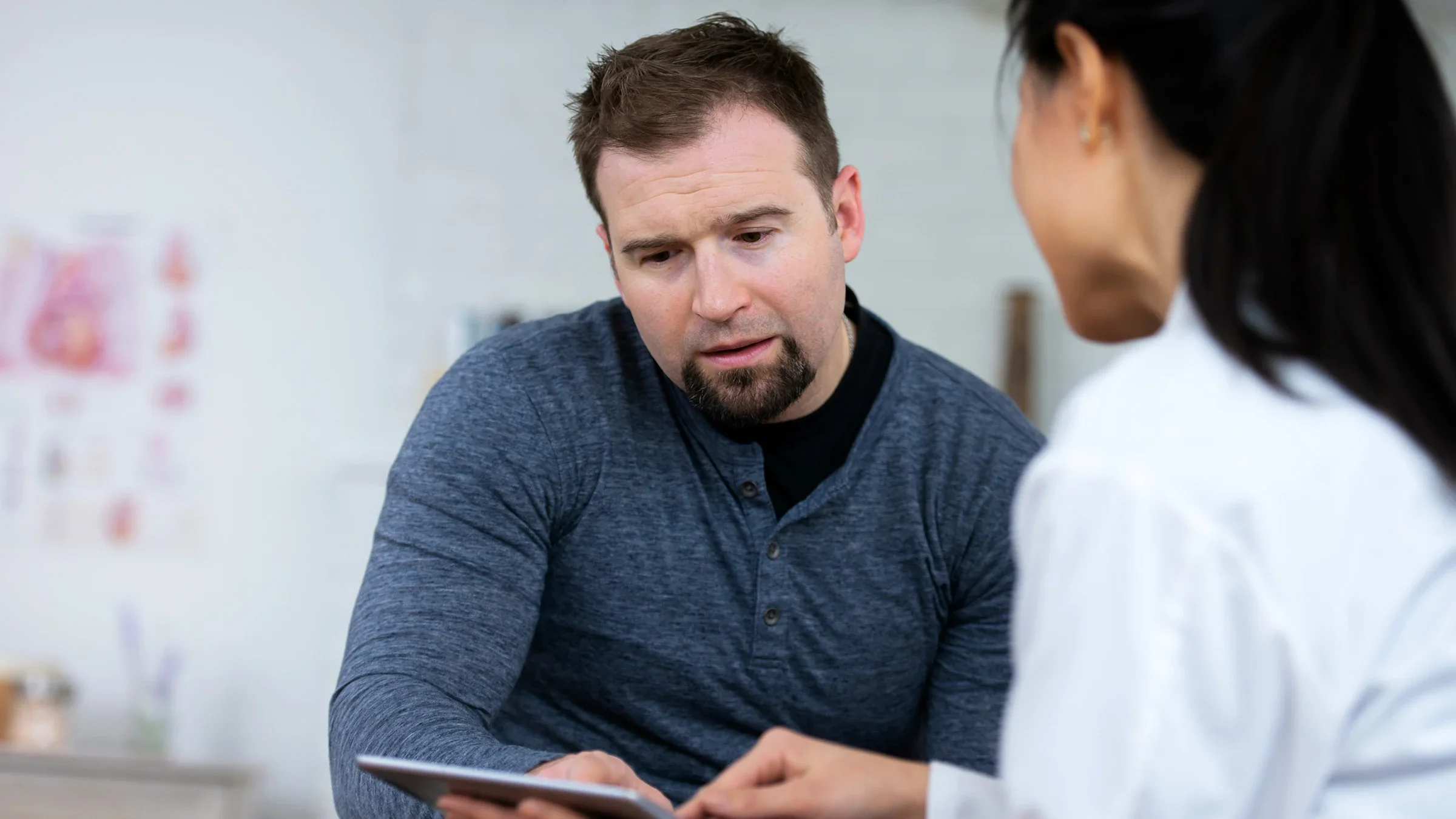 A man listens as a healthcare professional gives him test results.
FatCamera/E+ via Getty Images