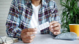 A man holds a blister pack of pills.
Credit: towfiqu ahamed/iStock via Getty Images Plus

