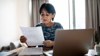 Medication Education: woman doing finances at home 1369206838