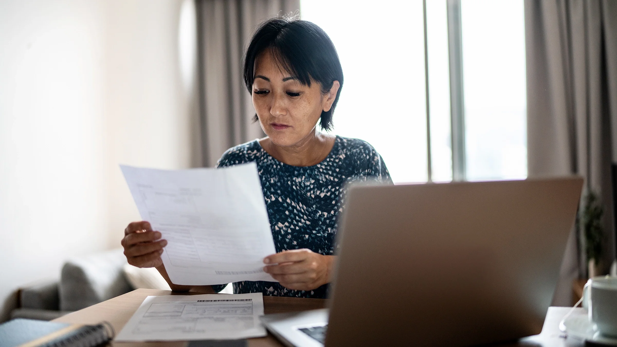 A woman manages her finances at home.