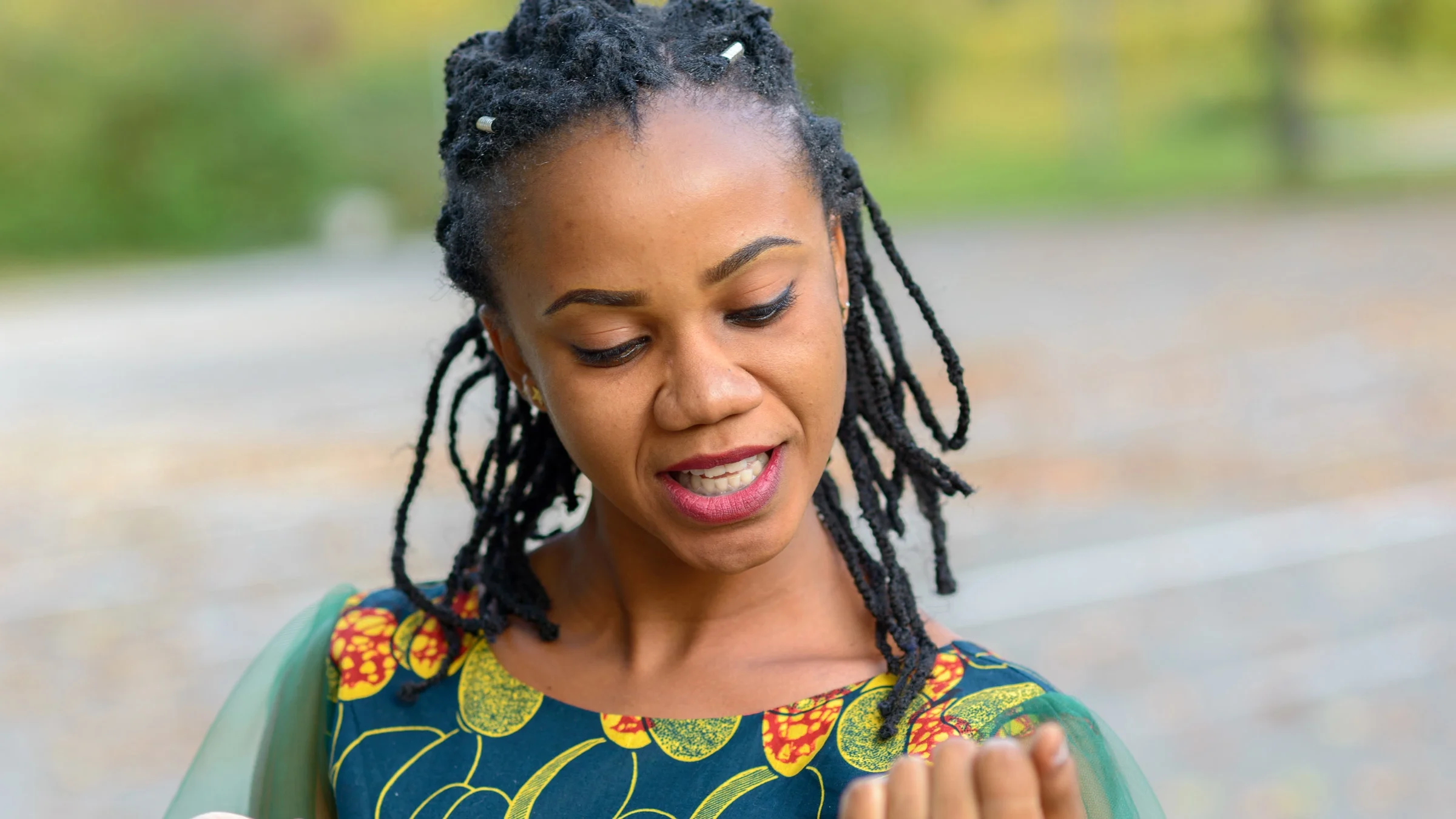 A person looking down at their nails.