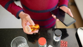 Safety: closeup man researching medication 1480671042