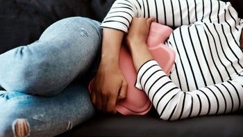 Health: Menstrual pain: closeup woman with hot water bottle 1286693128