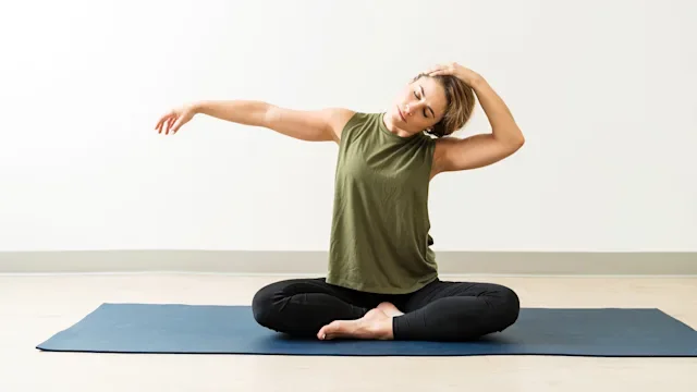 movement exercise: woman doing neck stretch 1168076425