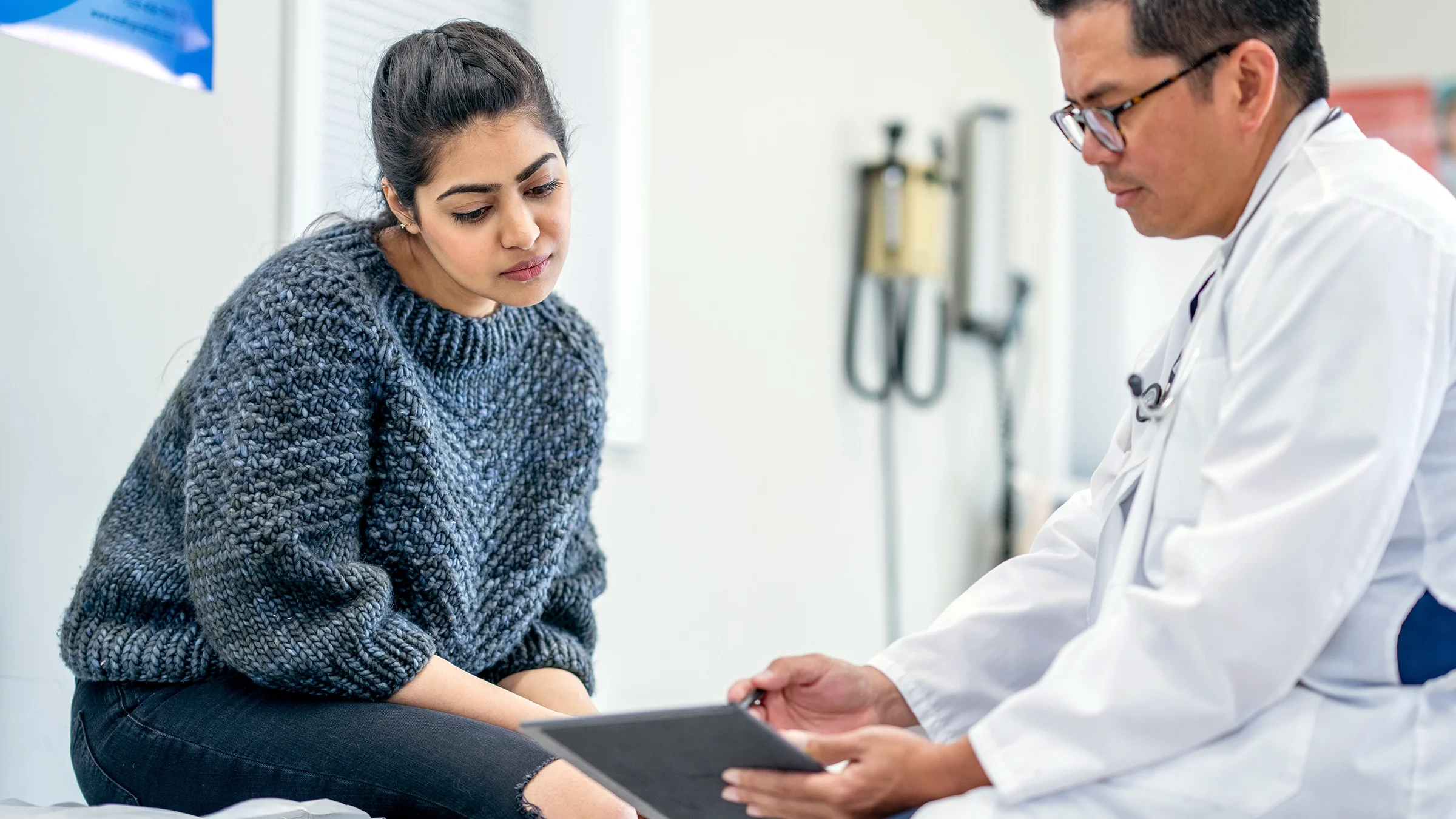 A woman listens to her doctor at a medical appointment.