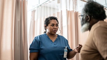 Medication Education: doctor speaking to patient in hospital 1341294443