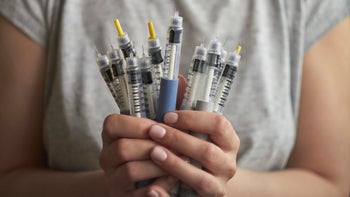 Health: Insulin lispro: person holding many insulin pens-1225342481