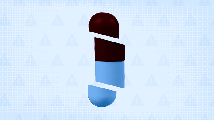 In the center of a blue background with texture and warning sign pattern is a red and blue capsule pill cut into thirds.