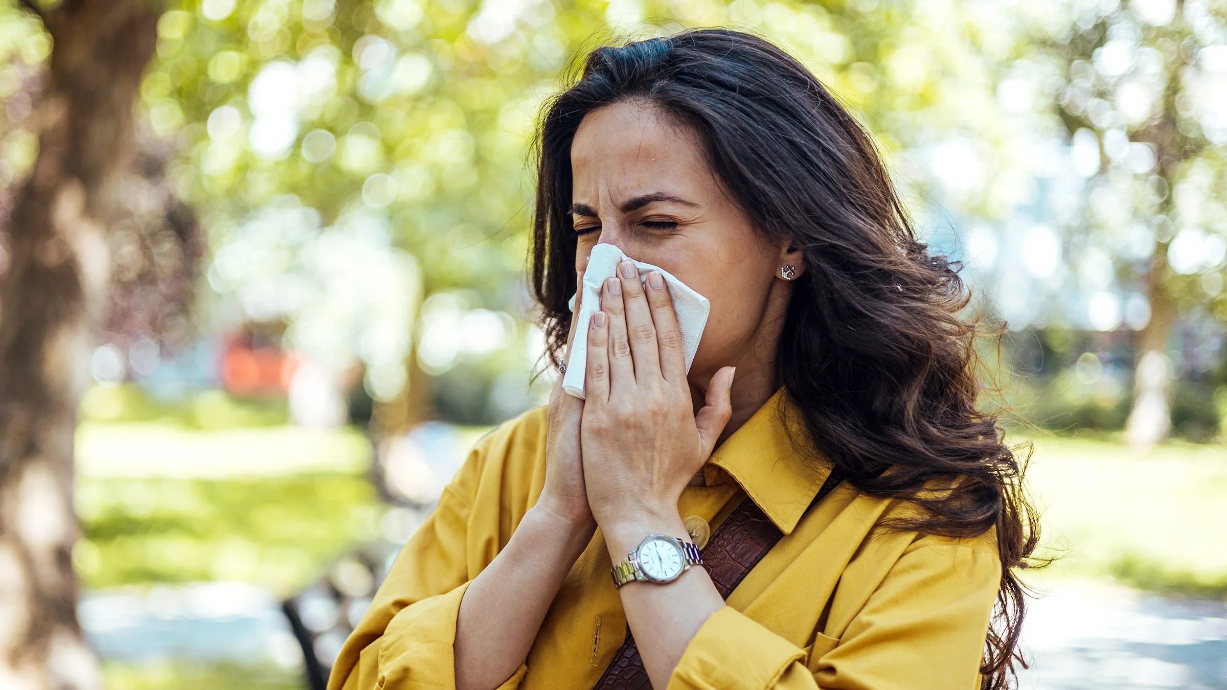 A woman blows her nose.