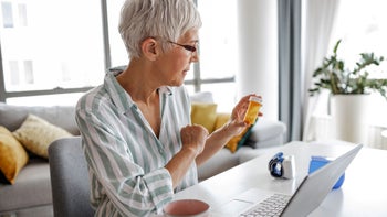 Health: Furosemide: senior woman reads Rx bottle-1368092182