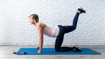 Movement exercise: woman doing donkey kick exercise 1222072264