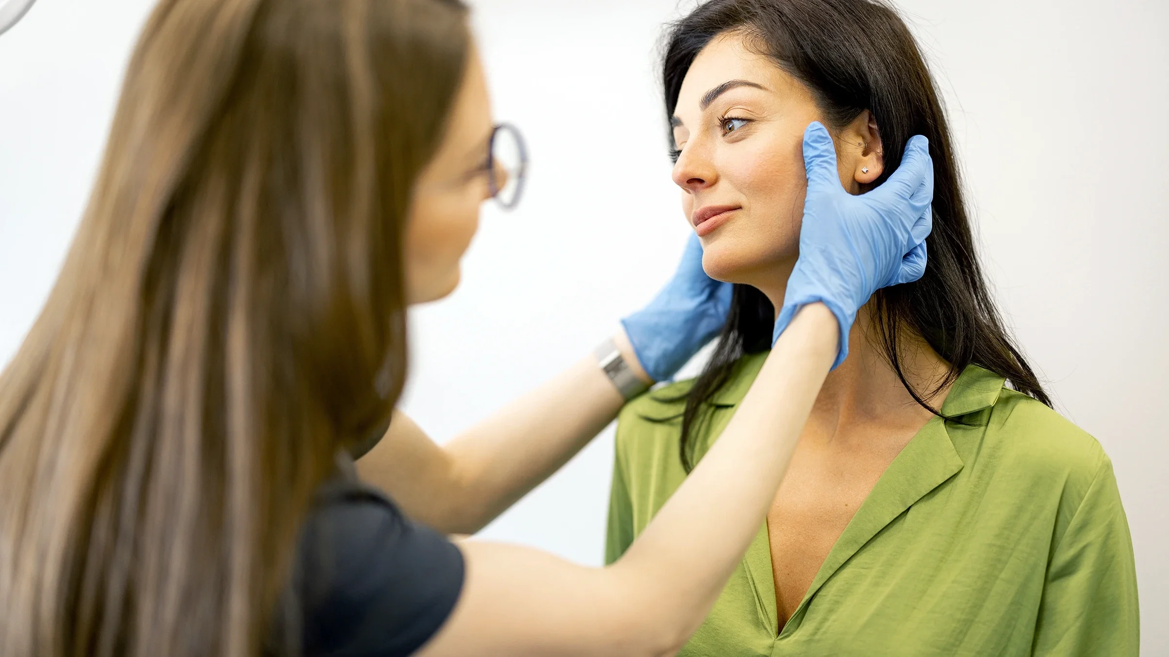 HCP examines a patient's face