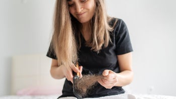 Mounjaro: woman cleaning hair brush 1456726217