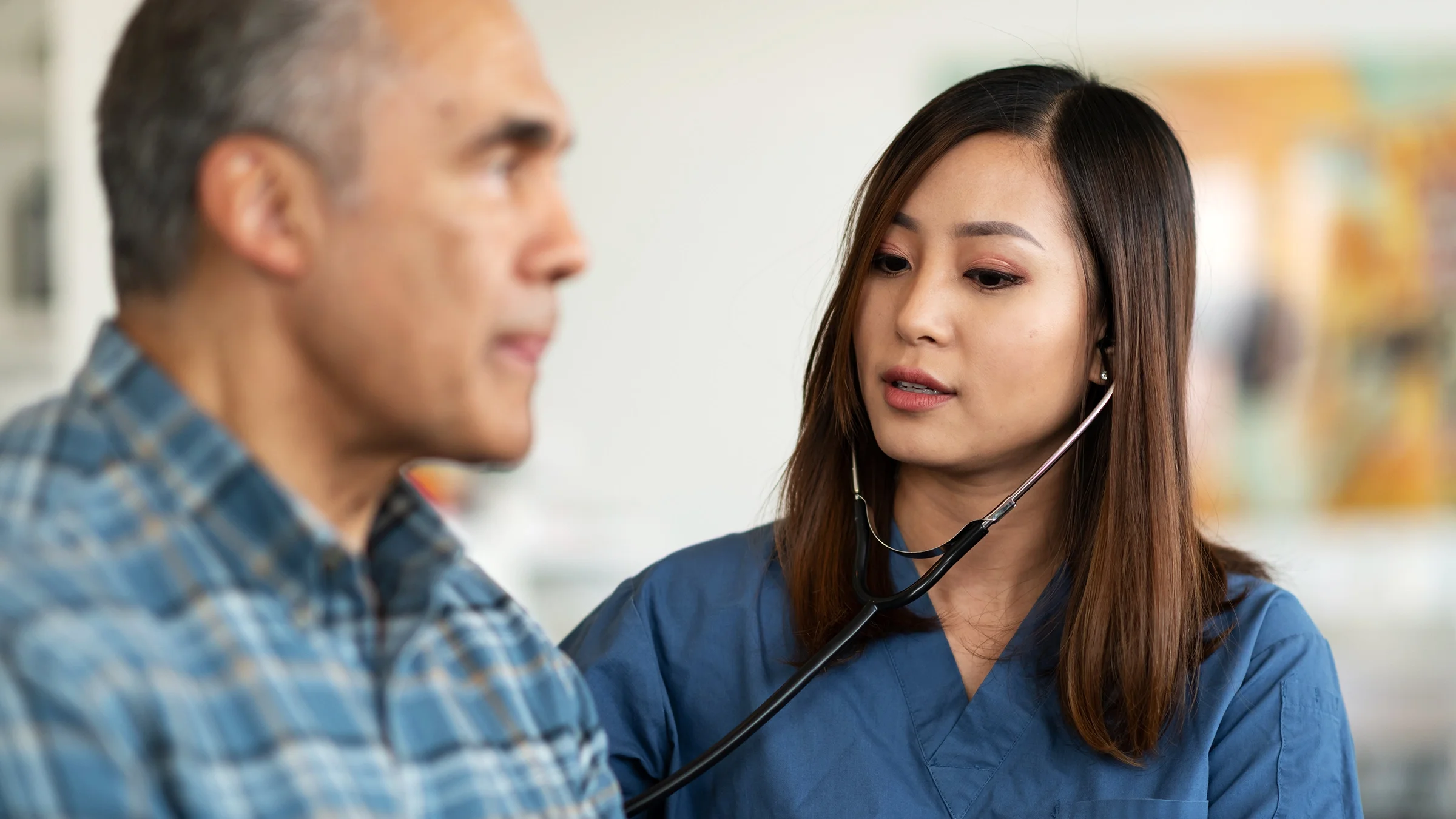 A doctor uses a stethoscope on a patient.