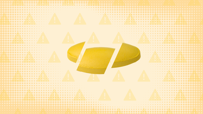 Light yellow background with texture and warning sign pattern. In th center is a yellow pill cut into thirds. 