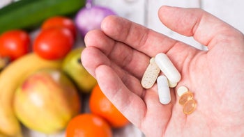 Diet nutrition: Food medication interactions: pills on hand blurred produce 508326350