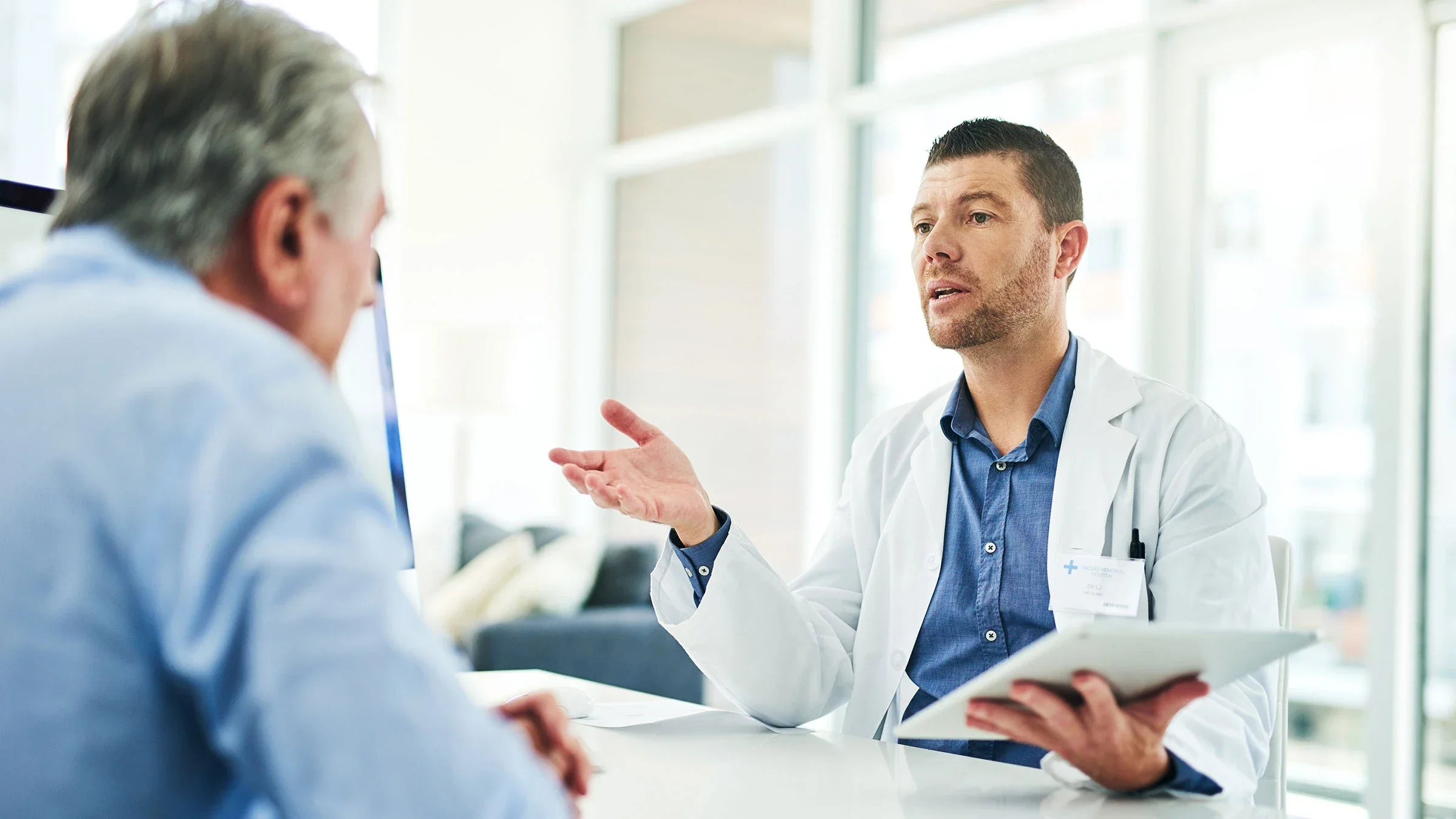 A doctor speaks with with a patient in his office
Moyo Studio/E+ via Getty Images 
