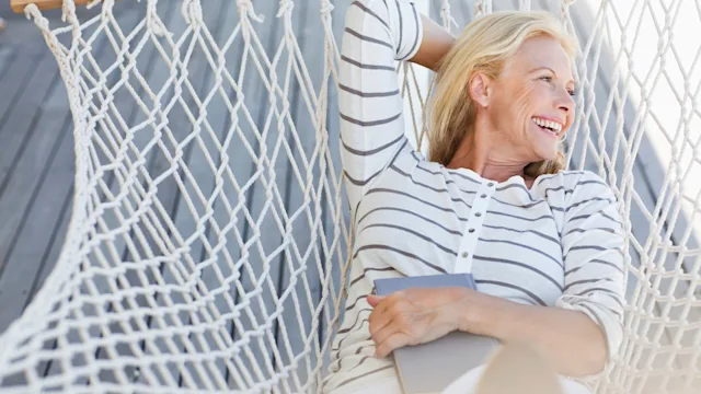 Presbyopia: Eye exercises: eyes taking break from reading in hammock-124206817
